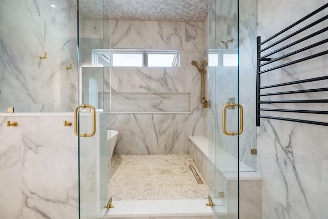 bathroom featuring an enclosed shower, radiator, and tile walls