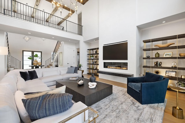 living room featuring wood-type flooring and a high ceiling