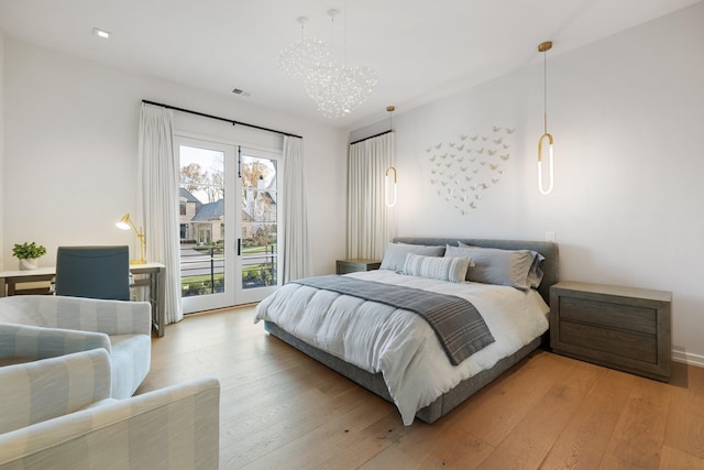 bedroom featuring hardwood / wood-style flooring and access to outside