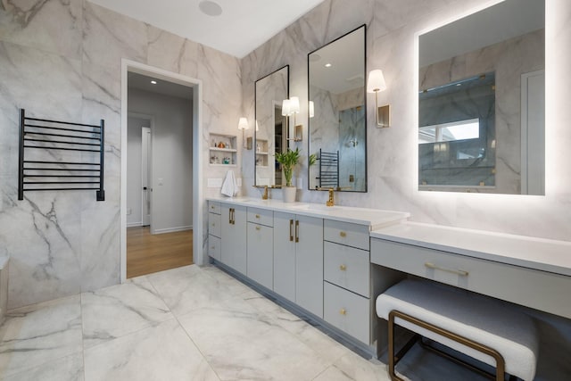 bathroom with vanity, tile walls, radiator, and walk in shower