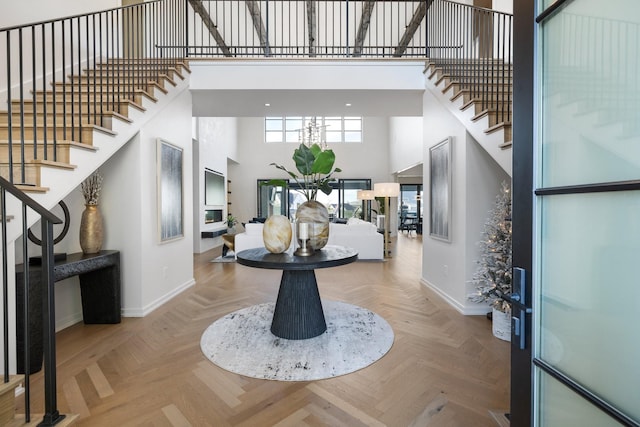 entryway featuring parquet floors and a towering ceiling