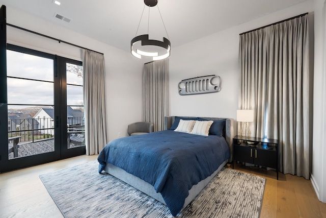 bedroom featuring hardwood / wood-style flooring and access to outside