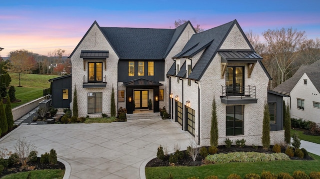 view of front of house featuring a balcony and a garage