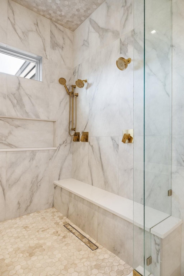 bathroom with a tile shower