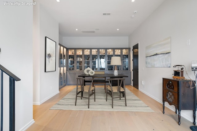 dining space with light wood finished floors, baseboards, visible vents, and recessed lighting