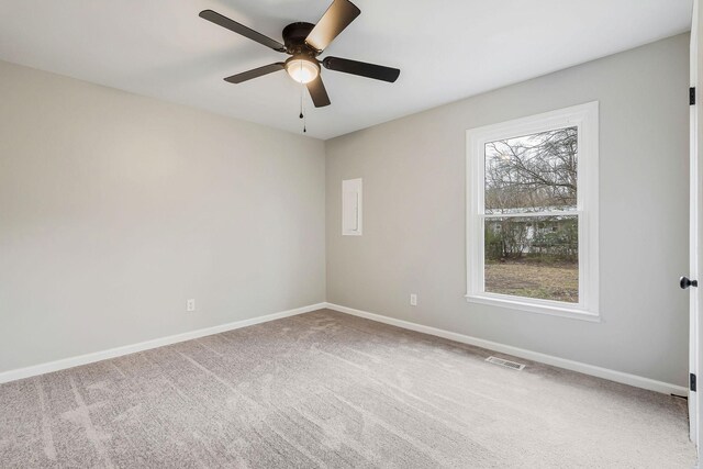 carpeted spare room featuring ceiling fan