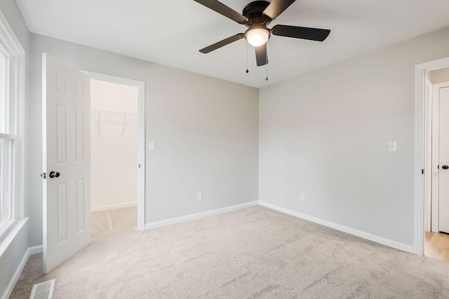 carpeted spare room with ceiling fan