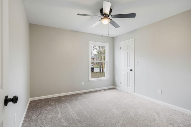 carpeted empty room with ceiling fan