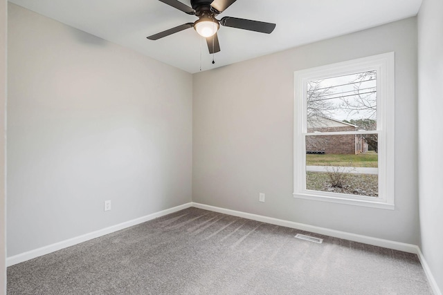 spare room with ceiling fan and carpet floors