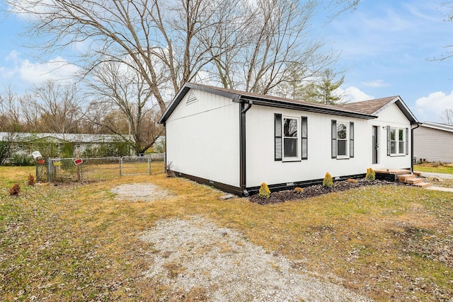 view of side of home with a lawn