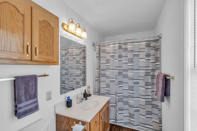 bathroom featuring vanity, hardwood / wood-style flooring, and curtained shower