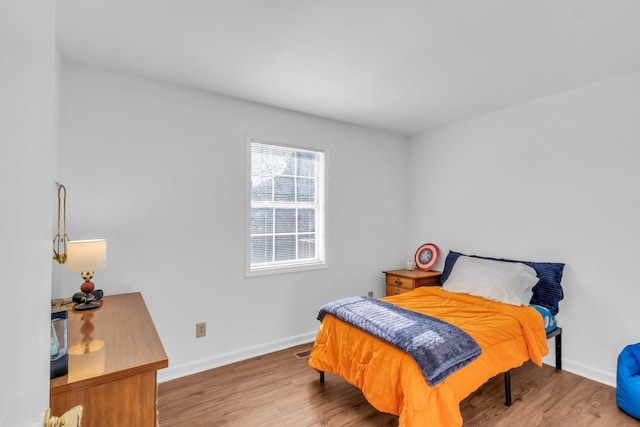 bedroom with hardwood / wood-style floors