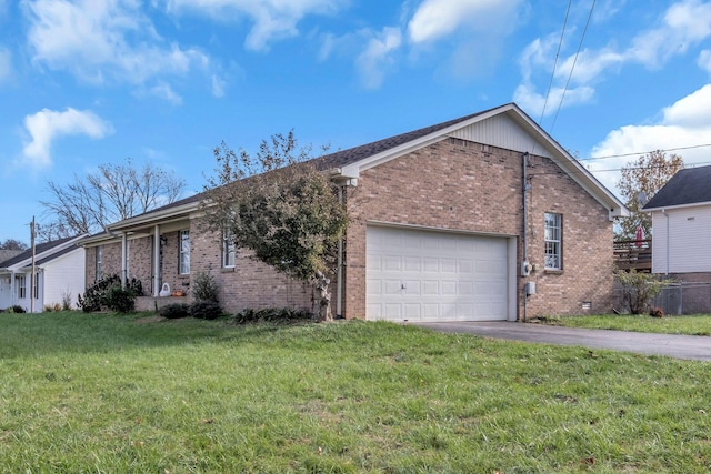 ranch-style home featuring a front lawn and a garage