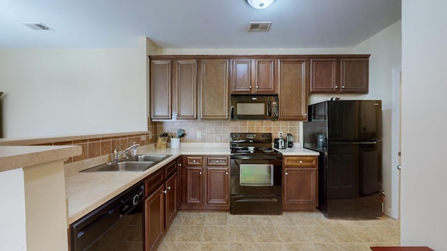 kitchen with sink, backsplash, and black appliances