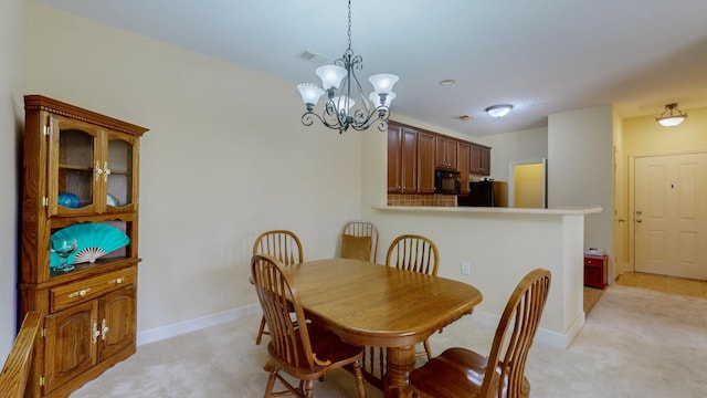 dining area with light colored carpet and an inviting chandelier