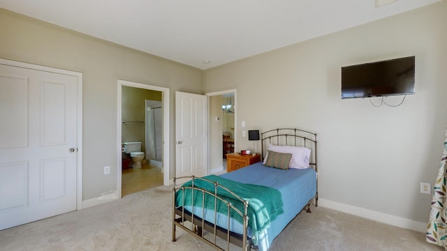 carpeted bedroom featuring ensuite bathroom