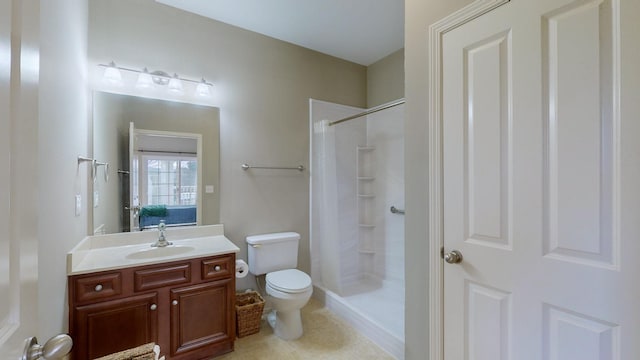 bathroom with vanity, toilet, and walk in shower