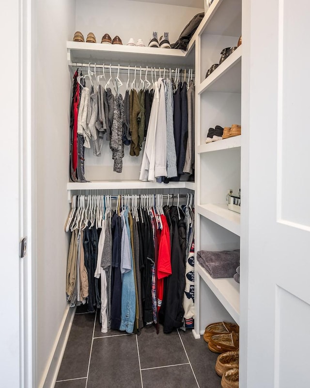 spacious closet featuring dark tile patterned flooring