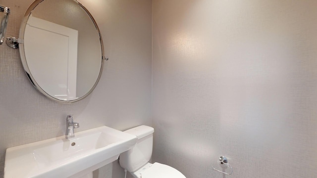 bathroom with toilet and sink