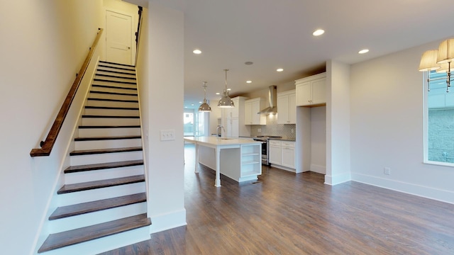 staircase with hardwood / wood-style flooring, a healthy amount of sunlight, and sink