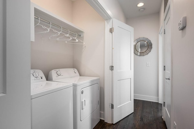 clothes washing area with independent washer and dryer and dark wood-type flooring