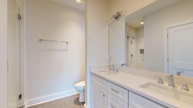 bathroom with tile patterned flooring, vanity, toilet, and a shower with shower door