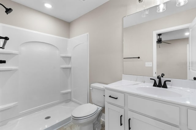 bathroom with ceiling fan, a shower, vanity, and toilet