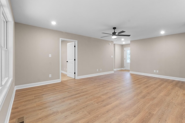 empty room with ceiling fan and light wood-type flooring