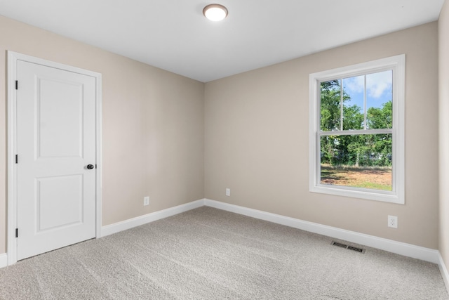 empty room with plenty of natural light and carpet floors