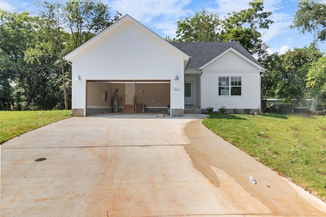 modern farmhouse with a garage and a front yard