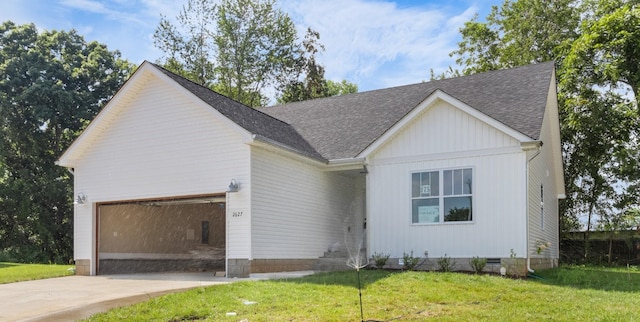 view of front of home featuring a garage and a front lawn