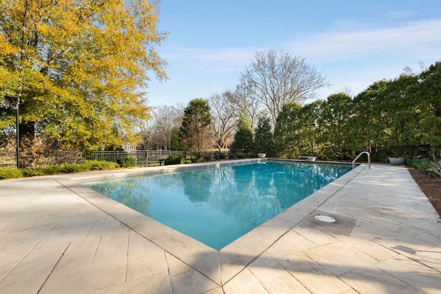 view of pool featuring a diving board and a patio