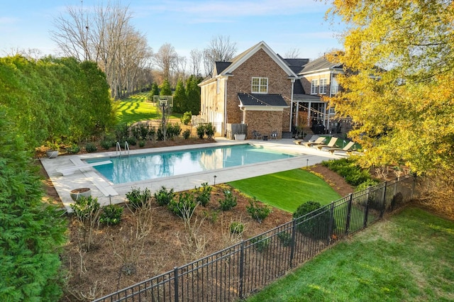 view of swimming pool featuring a yard and a patio