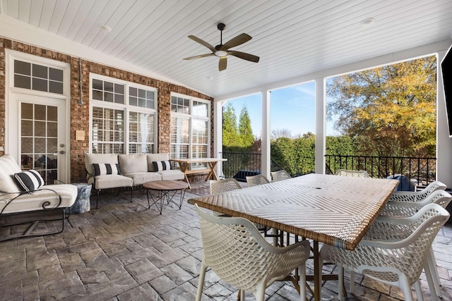 sunroom with ceiling fan and wood ceiling