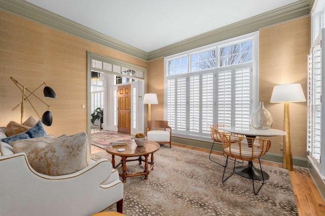 sitting room with wood-type flooring and ornamental molding