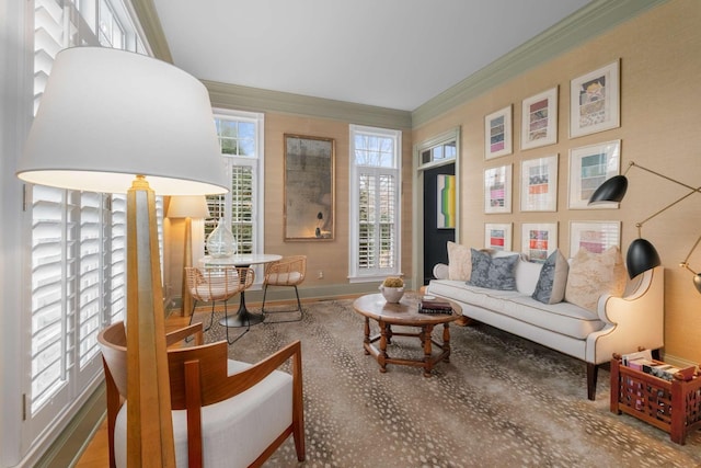 sitting room with wood-type flooring and ornamental molding