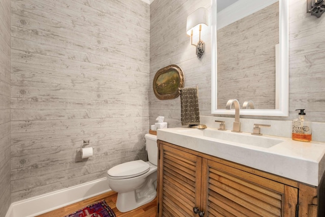 bathroom with vanity, hardwood / wood-style flooring, and toilet