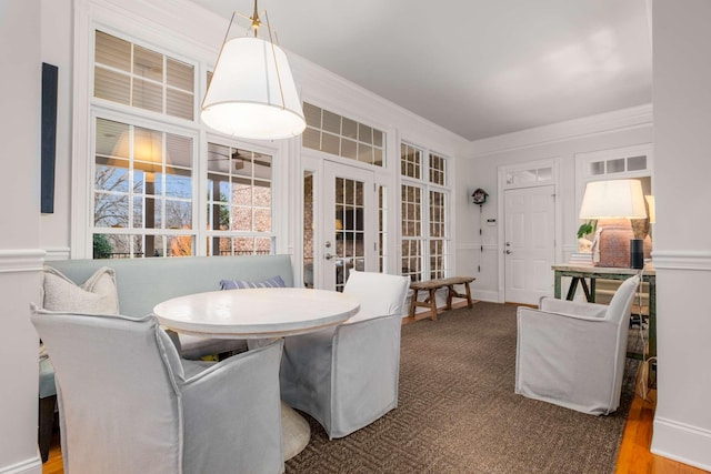 dining space featuring hardwood / wood-style flooring, ornamental molding, and french doors