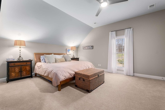 carpeted bedroom with ceiling fan and vaulted ceiling