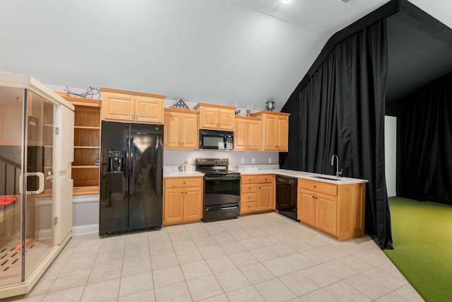 kitchen featuring vaulted ceiling, sink, black appliances, light tile patterned floors, and light brown cabinets