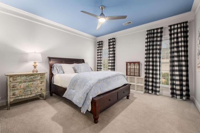 carpeted bedroom featuring ceiling fan and crown molding