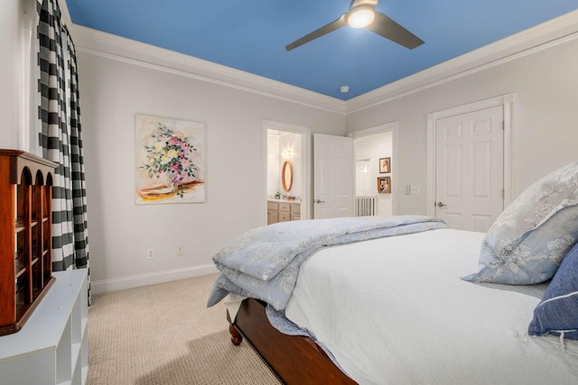 carpeted bedroom with ensuite bath, ceiling fan, and ornamental molding