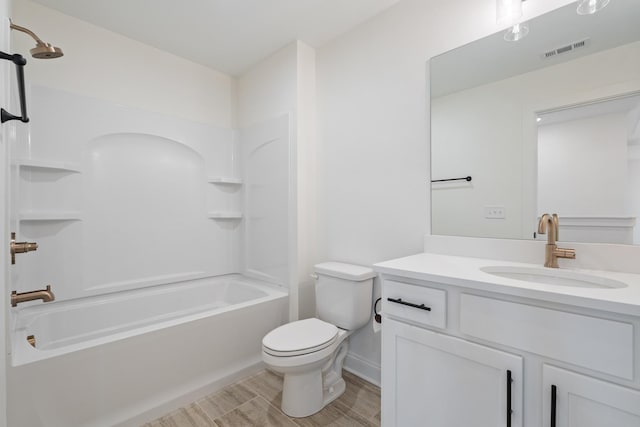 full bathroom featuring hardwood / wood-style floors, vanity,  shower combination, and toilet