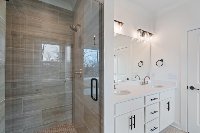 bathroom featuring a shower with door and vanity