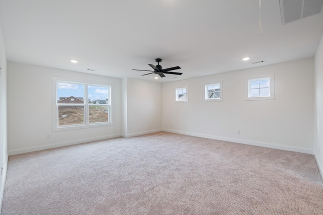 carpeted spare room featuring ceiling fan