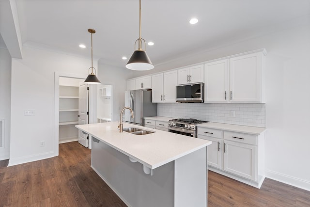 kitchen featuring white cabinetry, sink, stainless steel appliances, dark hardwood / wood-style flooring, and pendant lighting