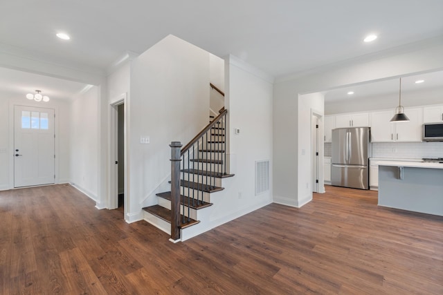 interior space with dark hardwood / wood-style flooring and ornamental molding