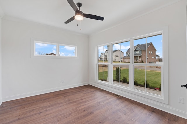 unfurnished room with wood-type flooring, ceiling fan, and ornamental molding