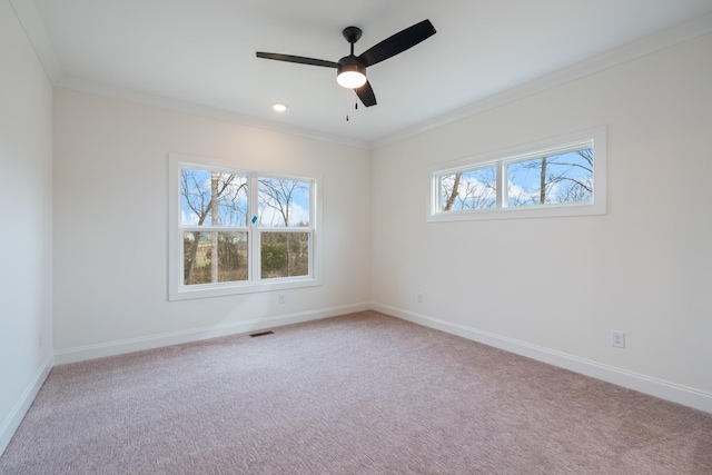 carpeted spare room with crown molding and ceiling fan