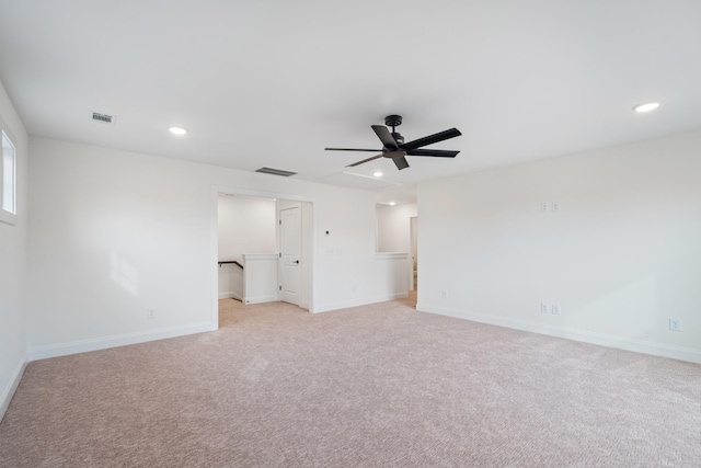 spare room featuring ceiling fan and light colored carpet